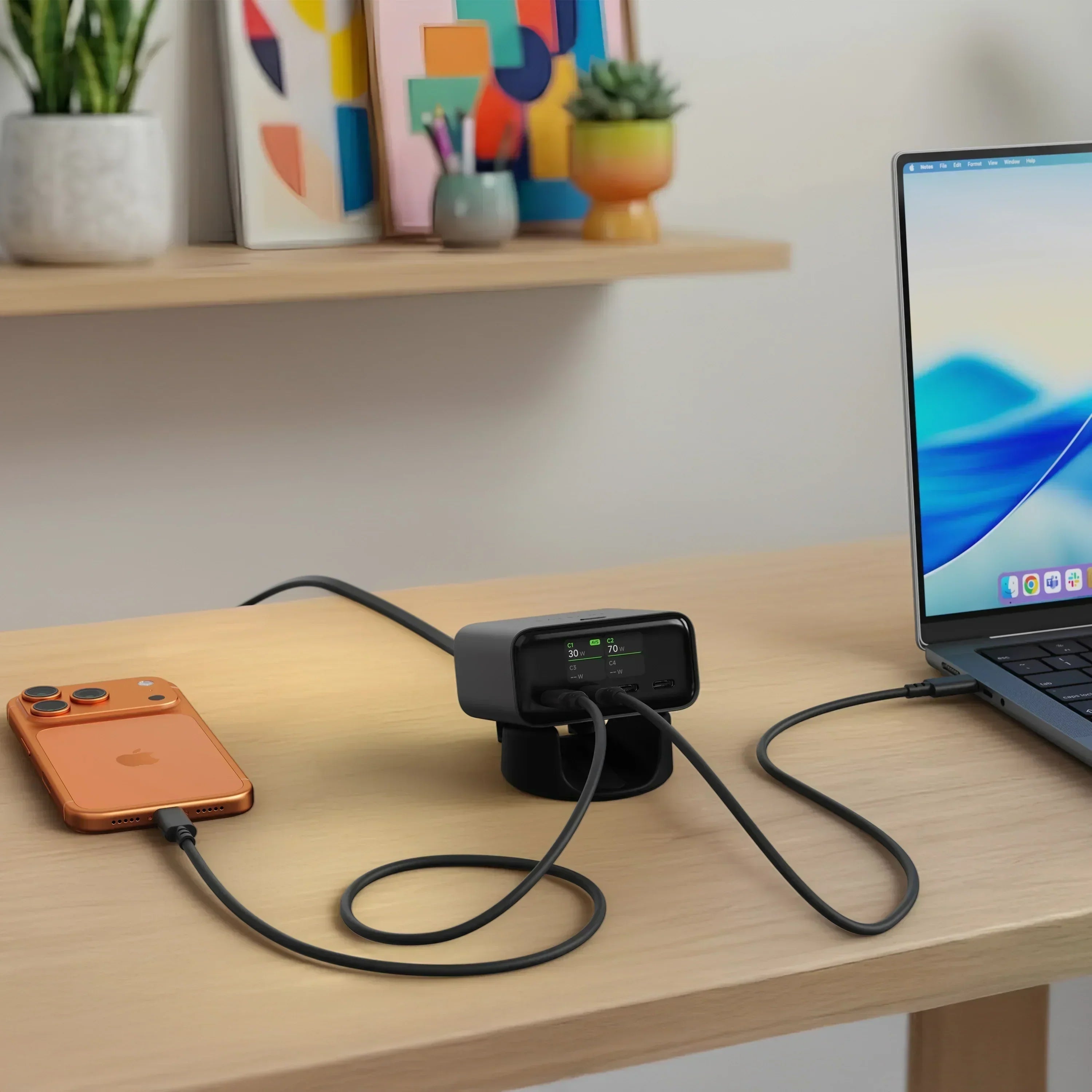 ChargeView™ 140W desktop charger featuring a digital power display, simultaneously charging a laptop and smartphone on a clean home office desk.