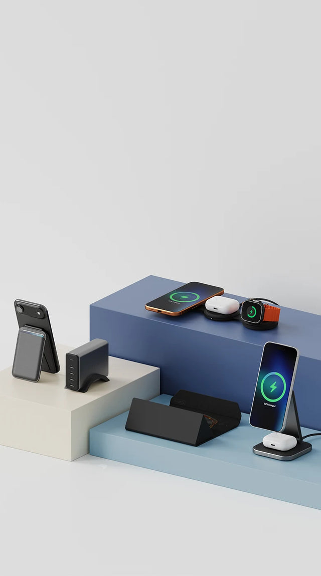 A collection of Satechi products set on elevated display platforms, featuring OntheGo™ 3-in-1 Charger charging an iPhone, Apple Watch, and AirPods, 2-in-1 Foldable Qi2 Wireless Charging Stand charging an iPhone and AirPods, Vegan-Leather FindAll™ Glasses Case, an iPhone attached to a Vegan-Leather Magnetic Wallet Stand, and a 165W USB-C 4-Port PD GaN Charger.