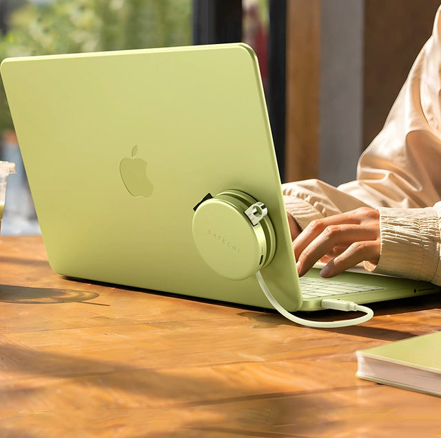 Citrus Satechi attached to the back of a citrus citrus MacBook Neo while a person types on it.