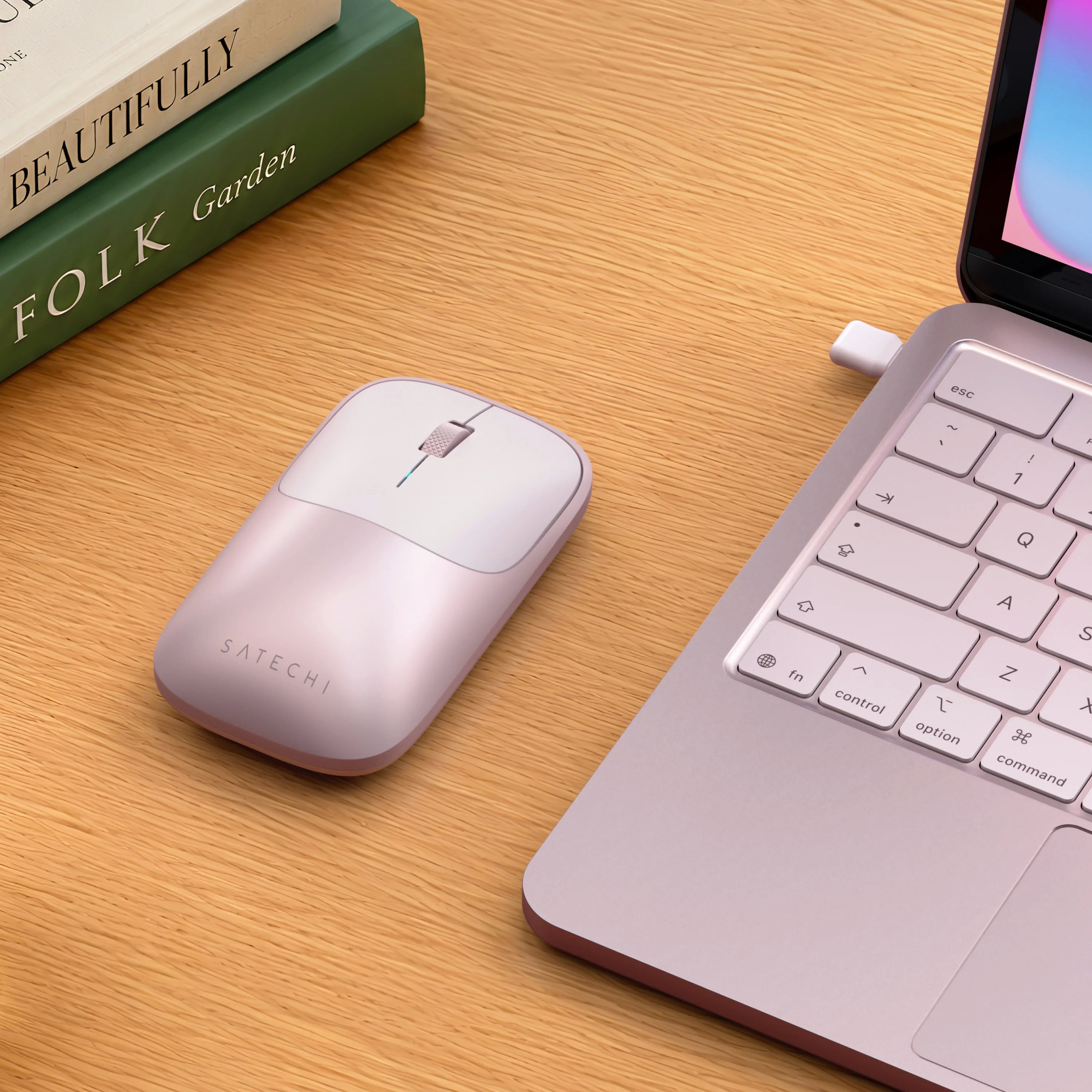 Satechi blush Slim EX Wireless Mouse on desk next to blush MacBook Neo.