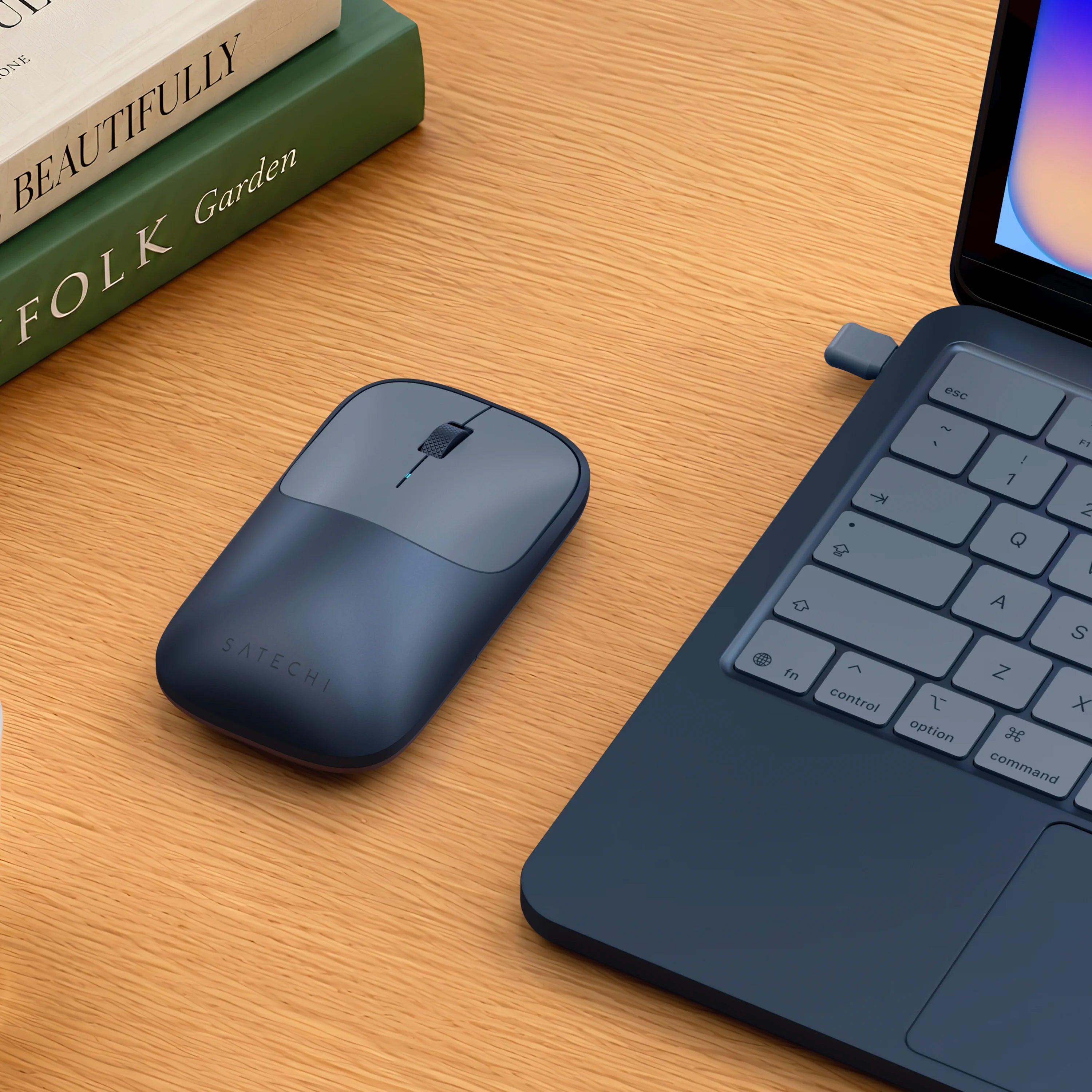Satechi indigo Slim EX Wireless Mouse on desk next to indigo MacBook Neo.