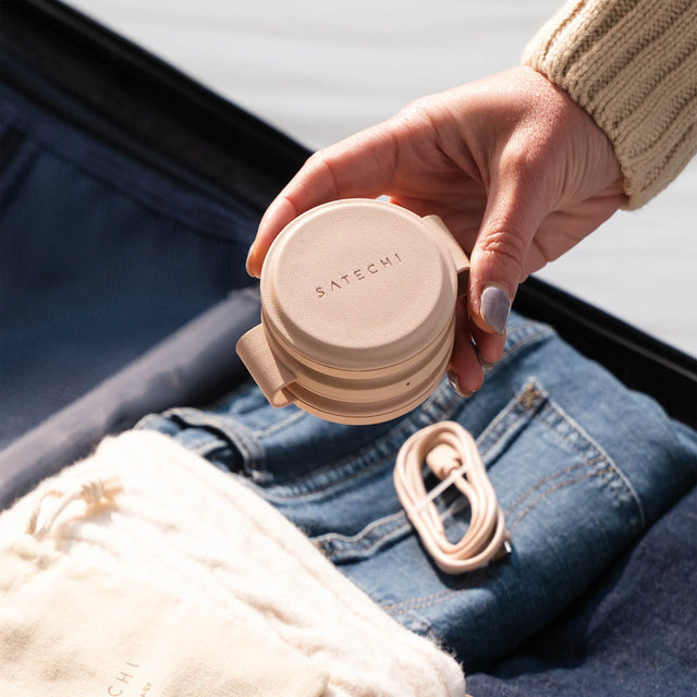 Satechi OntheGo™ 3-in-1 Charger in Desert Rose being packed into a suitcase filled with clothes, highlighting its compact and travel-friendly design.