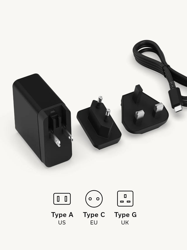 Satechi 3‑in‑1 Foldable Wireless Charging Stand with Qi2 25W power adapter, USB‑C charging cable, and interchangeable US (Type A) , EU (Type C) , and UK ( Type G) plug adapters.