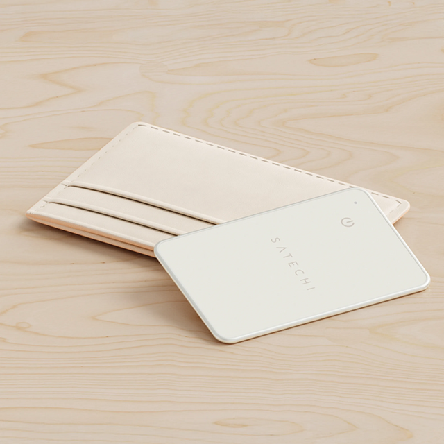 Sand Satechi FindAll Card placed beside a minimalist card wallet on a wooden surface.