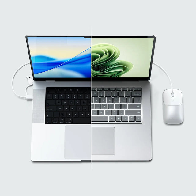 Two laptop screens displaying different wallpapers, one running macOS and the other running Windows, demonstrating cross‑platform compatibility with the Slim LX Wired Mouse.